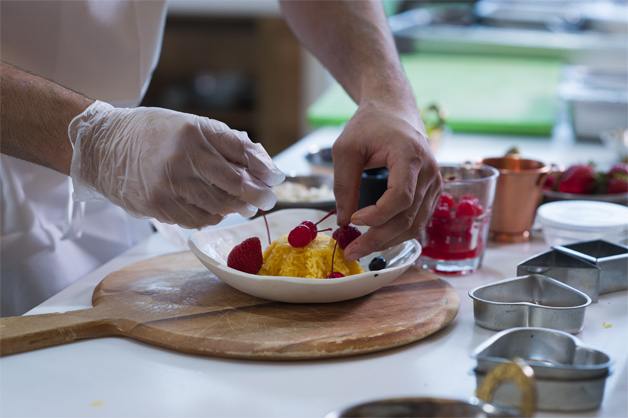 Rice being plated with cherries