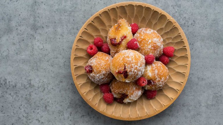 Photo of the raspberry jam filled donuts on a plate