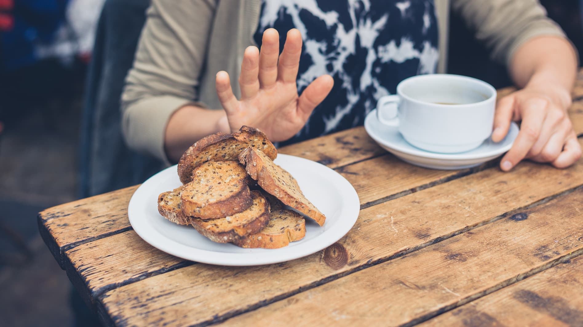 Image of a man saying no to bread because he is gluten free