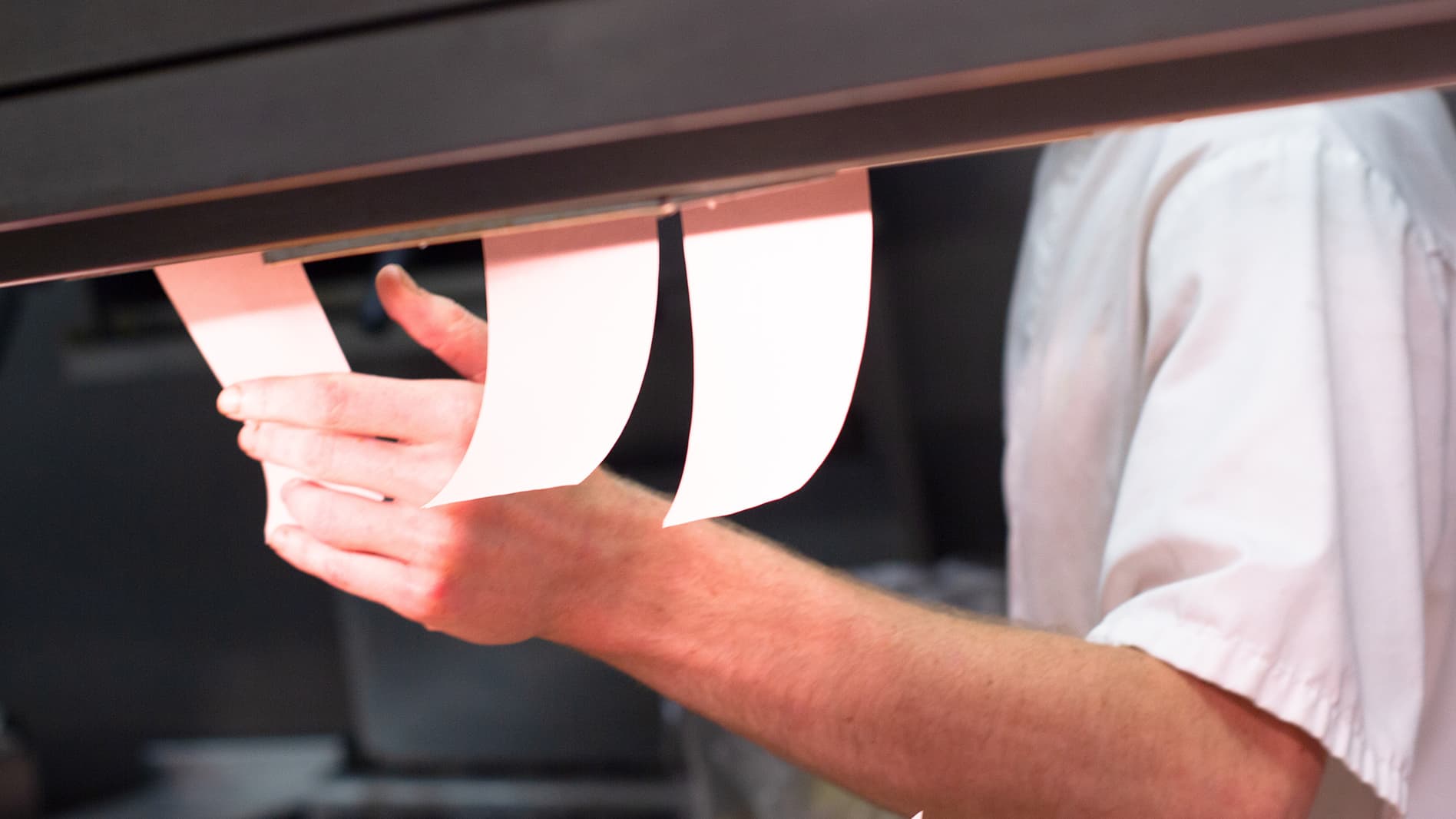 Chef pulling tickets off the pass in the kitchen