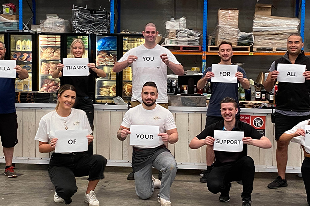 a group of people hold signs with thank messages